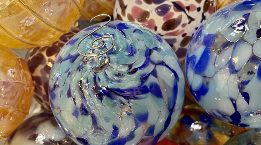 pile of brightly colored hand blown glass ornaments
