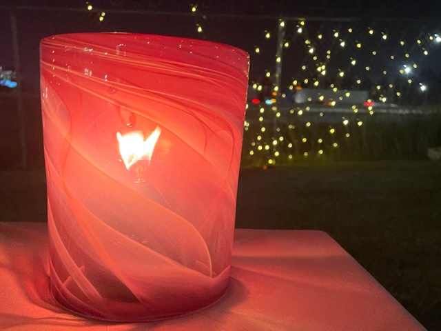 Cylindrical ruby lantern on a background of sparkling lights