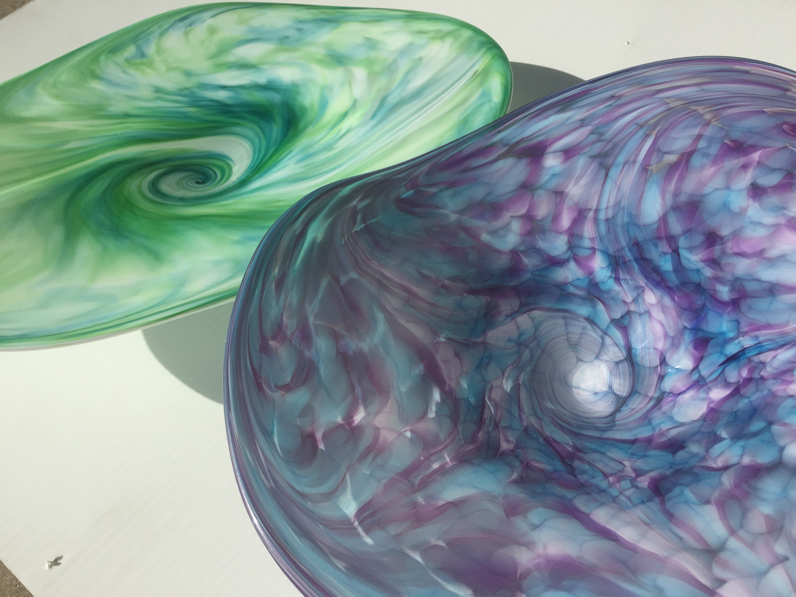 purple and green wall platters that were made in a glassblowing experience