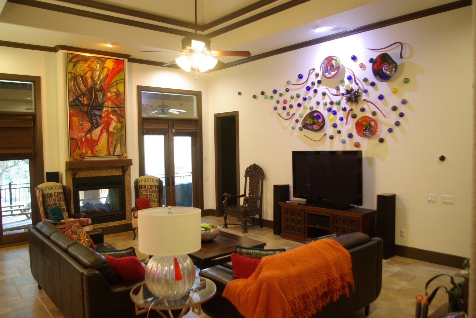 Luxurious living room with large blown glass wall installation on the right